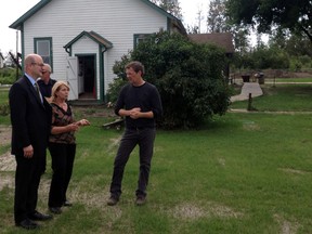 Municipal affairs minister Doug Griffiths tours Heritage Park with Fort McMurray-Conklin MLA Don Scott and Fort McMurray Historical Society director Roseann Davidson. Griffiths was surveying flood water damage in the region on Wednesday. SUPPLIED PHOTO