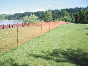 Temporary fencing has been placed in front of the river bank in the Devon Lions Campground.