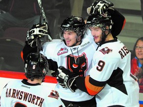 Sherwood Park’s Greg Chase (centre) celebrates after scoring a goal for the Calgary Hitmen during this year’s Western Hockey League playoffs. Photo by Stuart Dryden QMI Agency