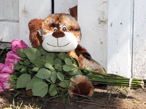 A memorial has been set up outside a home after a three-year-old girl left alone in an vehicle died in Edmonton on Wednesday, July 3.