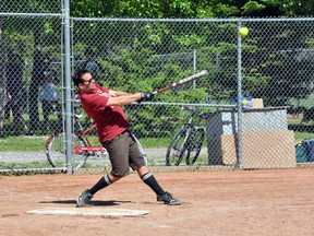 Bear Street Tavern's Kyle Pressman connects with the ball during the Banff slo-pitch mixed softball team's game against the Rimrock Rock Stars on Sunday, June 30. The Bear Street Tavern won. CORRIE DIMANNO/BOW VALLEY CRAG & CANYON/QMI AGENCY