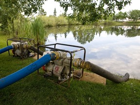 Two pumps operating in the lake at Lakeland Village in Sherwood Park on Friday, June 28. The village has experienced recent flooding and drainage issues. Ian Kucerak/Edmonton Sun/QMI Agency