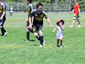 Sushi House's Yuji Akiyama gets a quick congratulations from his daughter Len, 4, after he scored the second goal against the Banff Springs on Sunday, June 29. Sushi House won 2-0. CORRIE DIMANNO/BOW VALLEY CRAG & CANYON/QMI AGENCY