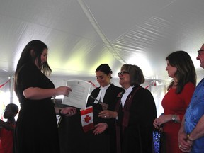 The Citizenship Ceremony embraced 50 new Canadians on July 1. Participants received their citizenship certificate from presiding Citizenship Judge Laurie Mozeson, who also administered the oath of citizenship. They then went down a line of dignitaries including Edmonton-Spruce Grove MP Rona Ambrose, Parkland County Mayor Rod Shaigec and Stony Plain Mayor William Choy, all of whom shook their hands and congratulated them. - April Hudson, Reporter/Examiner