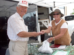 At the Urban Park Farmer’s Market Thursday, George Majtanic buys a frozen steak from Noella Farrell, who operates Mattagami Heights Limousin Farms on Sandy Falls Road. Farrell, who is a third-generation farmer, is gratified to see a renewed interest and investment in agriculture in this region the last couple of years.