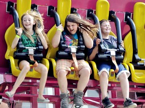 Samantha Folland, 11, left, Kelly Miller, 11, and Marshall Miller, 9, get their money's worth out of all-you-can-ride bracelets at the Chatham-Kent Ribfest in Tecumseh Park  Thursday. The festival, which features seven ribbers, 20 bands, vendors and a midway will run 11 a.m. to 11 p..m. Friday through to Sunday. DIANA MARTIN/ THE CHATHAM DAILY NEWS/ QMI AGENCY
