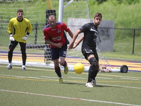 Kingston FC midfielder Catalin Lichioiu, centre, attempts to take possession of the ball during a Canadian Soccer League match against the St. Catharines Roma Wolves at Queen’s University’s west campus on Sunday. Kingston hosts two-time defending league champion Toronto Croatia on Saturday. (Danielle VandenBrink/The Whig-Standard)
