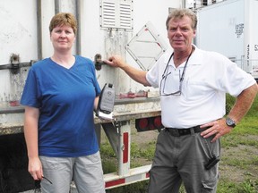 Lisa Cook and Steve Kelly show off their new product, SSL — seal, shield and lock — meant to secure transport trailers and keep their cargo inside.
Staff photo/KATHRYN BURNHAM