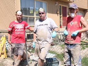 KEVIN RUSHWORTH HIGH RIVER TIMES/QMI AGENCY. Clayton Schmitt and Rylan Schmitt were helping their father, Mike Colwell clean out their grandparents place (Bill and Betty Colwell) in southwest High River on Tuesday.