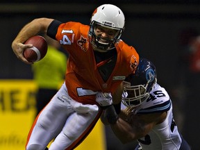 B.C. Lions quarterback Travis Lulay is sacked by Toronto Argos linebacker Robert McCune in Vancouver on Thursday. (Reuters)
