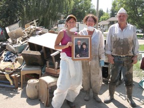 KASSIDY CHRISTENSEN HIGH RIVER TIMES/QMI AGENCY From left, Cheryl Schroeder, Terry Perello and Phil Rowland are pitching in to help their elderly parents clean out their flood damaged family home.