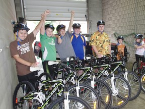 Ten Woodstock kids earned a Raleigh bike On July 5, 2013 through a partnership between Tim Hortons and the Woodstock Police Service. From left Jake Rutherford, Tristian Watson, Jordan Martel, Jacob Perry, Zach Perry, Desmond McLachlen, Mya Eichler, Heidi Eichler, Natalie Marin and McKenzie Knox. (HEATHER RIVERS, Sentinel-Review)