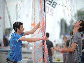 Craig Hamilton, 17, and Jack Trim, 16, of the Royal Hamilton Yacht Club, prep their sails at the Sarnia Yacht Club Friday, July 5, 2013. Young sailors from across the Great Lakes participated in a racing clinic Friday before the start of Sarnia Sailfest this weekend. (BARBARA SIMPSON, The Observer)