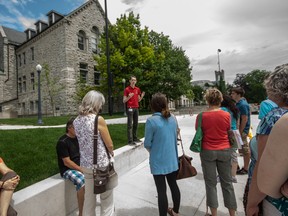 Chris Swioklo, an upper year student at Queen's gives a campus tour to incoming students as part of Queen's Summer Orientation to Academics and Resources program. 
Sam Koebrich for The Whig-Standard