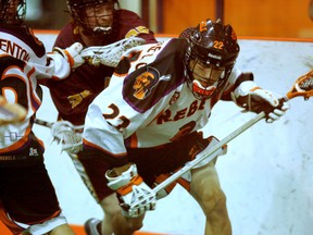 Six Nations Rebels' Brayden Hill runs with the ball to get loose behind his net as a Brampton Excelsiors player chases him Friday in Game 1 of the best-of-three Ontario Junior B Lacrosse League Western Conference quarter-final series at the Iroquois Lacrosse Arena. (DARRYL G. SMART Brantford Expositor)