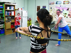 Participants at a Girls Inc. art day get some exercise with hula hoops. The 20 girls who attended chose between visual arts, dance and poetry. Today file photo
