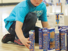 Cale Warren, 9, raised 1,464 boxes of Kraft Dinner for the Vulcan Regional Food Bank, but before sending the boxes off, he lined them up like dominoes and with one gentle push they all came toppling down June 20 at Champion School.