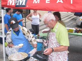 Kenora Special Olympics volunteers Scott Malmo and Lloyd Carleson work the grill, barbecuing hotdogs and hamburgers to raise donations in support of the local program at M+M Meats on Lakeview Dr., Saturday, July 6.
REG CLAYTON/Daily Miner and News