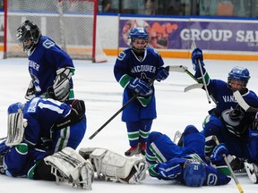 The BC Junior Canucks celebrate their 4-3 in a shootout win over the California 03's in their semi-final game at the Brick Invitational Super Novice Hockey Tournament at West Edmonton Mall on July 6, 2013. TREVOR ROBB QMI AGENCY