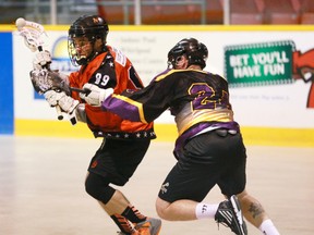 The Owen Sound Quantum Properties NorthStars' Phil Dempsey loses the ball when he's checked by Norwood James Gang's Mark Temple during the N'Stars 10-6 win on Saturday in Ontario Lacrosse Association Senior B League play.