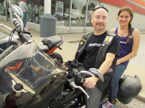 Bob Thomas and his daughter, Victoria, climb onto his bike Saturday for the 10th annual Ride for Our Cancer Kids (R.O.C.K.). The Thomas family of Corunna have been holding the fundraiser every year since Victoria's twin died from cancer just shy of her third birthday. (Observer file photo)