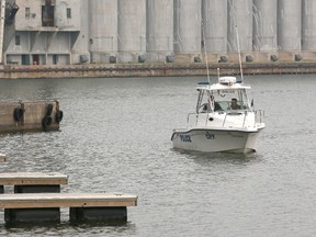 An OPP boat searches for the boater of missing fisherman Larry Quesnel in Owen Sound Harbour late last week. James Masters photo.
