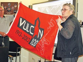 Louise Schmidt, Vulcan Centennial Committee co-chair, and Mike Hameluck recently presented to Vulcan's Town council the centennial flag, many of which have since been seen raised on flag poles around town.