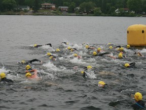 Competitors leave the gate for the 1,500 swim event at the start of the Olympic Triathlon hosted by Borealis Multi-Sports, Sunday, July 7.