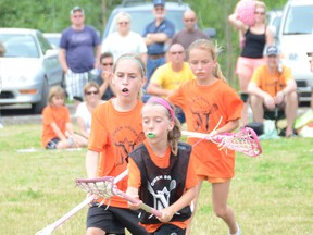 Meaghan Prentice (front) craddles the ball while Jessica Elines (left) and Sarah Pringle (back) track her down on defense during the Owen Sound Field Lacrosse's learn-to-play program's exhibition game on Sunday at the Kiwanis Soccer Complex.