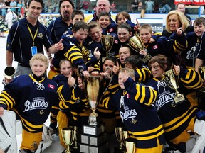 The Toronto Bulldogs celebrate their third straight Brick Invitational Super Novice Hockey Tournament championship at the Ice Palace in West Edmonton Mall on Sunday, July 7, 2013. The Bulldogs won the title after downing the B.C. Junior Canucks 3-1. TREVOR ROBB QMI AGENCY