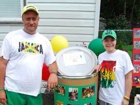 Case Verseegen, left, and Amber Reid held a fundraiser Saturday, July 6, 2013 called Jamaican Em' Happy, to raise money to send barrels of supplies to a school in Jamaica. The garage sale was expected to raise more than $1,000.  (TARA BOWIE, Sentinel-Review)