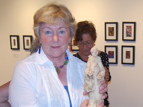 Paulette Robertson holds one of her smiling monks at the opening of the Small Works exhibit at the Ingersoll Creative Arts Centre Sunday. (TARA BOWIE, Sentinel-Review)