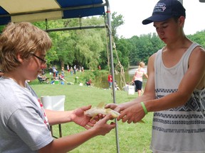 High school students volunteering at the Norwich Optimist fishing derby were kept busy Saturday with more than 100 fish caught. (TARA BOWIE, Sentinel-Review)