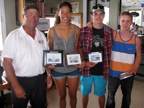 Sailfest 2013 race officer Bill Abbott presents three of the top sailors in the laser radial class with their trophies Sunday at the Sarnia Yacht Club. From left is Abbott, Sarah Douglas of Ashbridges Bay Yacht Club who was first female and placed first overall; Robert Lalonde of Frenchmen's Bay Yacht Club who won second overall and Matti Muru from Port Credit Yacht Club who placed third. (CATHY DOBSON, The Observer)