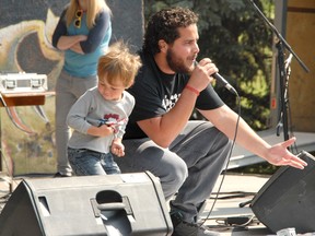 Jocelyn Turner/Daily Herald-Tribune
Two year-old Aiden Sterr, left, rocks out to the music of Tasman Jude on Sunday in Muskoseepi Park during the Alberta Bound and Determined: Songs for the South Flood Relief benefit concert. Band members, including singer Caled Bart came up and danced and sang with Sterr while he was on stage playing air guitar.