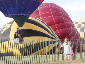 Two girls watch a hot air balloon lift off at a previous Lift-Off festival in Lamoureux Park.
File photo