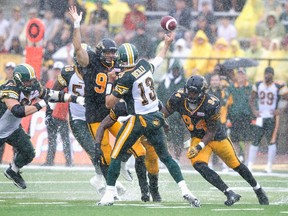 Eskimos quarterback Mike Reilly gets a pass off just in time (Fred Thornhill, Reuters).