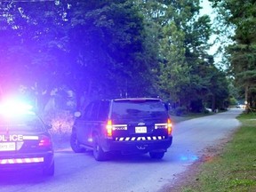 Norfolk OPP block off a road in Long Point, Ont., after receiving a call about a live explosive, Sunday, July 7, 2013. (EDDIE CHAU/QMI Agency)