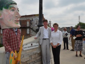 City Mayor Deb Haswell and the Tom Thomson Art Gallery's city representative, Coun. Ian Boddy, join a jumbo-sized likeness Tom Thomson Monday at a ceremony to dedicate the bridge in Tom Thomson's honour. It was also the 96th anniversary of the mysterious disappearance of the famous Canadian painter.