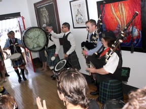 Sugar Shack Tattoo’s grand opening on July 6 featured performances by world champion pipers and drummers to mark the reopening of the shop at the historic birthplace of the Kincardine Scottish Pipe Band in 1908. L-R: Graham Kirkland on snare, Craig Colquhoun on bass drum, Tyler Fry on tenor drum, Greg McAllister of Scotland on bagpipes alongside Kincardine Scottish Pipe Band pipe major Jennifer Farrell. (TROY PATTERSON/KINCARDINE NEWS)