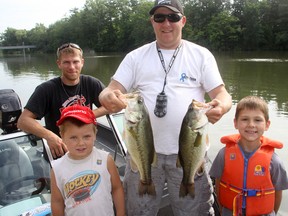 Shawn Beaumont shows off a pair of nifty bass caught during the Tillsonburg Kiwanis Club Cops, Kids and Canadian Tire Fishing Derby Saturday morning at Lake Lisgar, along with (front row, Kaleb and Tristan Beaumont) and rear, left, Brian Beaumont. The longer of the two stood up as the top bass (by length) caught in the adult bass division. Jeff Tribe/Tillsonburg News