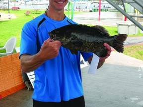 Rob Jardine of Gananoque proudly holds his 4 lb. bass, which garnered him a $1,000 prize during the Big Bass Challenge on the weekend. More than 300 anglers took part in the catch-and-release competition that took place in the St. Lawrence River.                 Wayne Lowrie - Gananoque Reporter