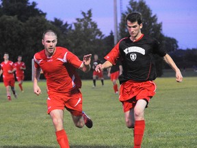 MONTE SONNENBERG Delhi News-Record
Justin Moore, left, of the Norfolk Royals, scored once in a 4-3 loss to St. Thomas on Friday. Here, Moore vies for the ball with St. Thomas forward Jay Marchand.