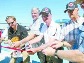 Among those cutting the ribbon to officially open the new Mayerthorpe Aquatic Centre are, from left, Woodlands Mayor Jim Rennie, George Cockle of the Kinsmen Club of Whitecourt, MLA George VanderBurg and Reeve Lloyd Giebelhaus of Lac Ste. Anne County. Gerard Aubin of the Kinsmen Club of Whitecourt and Mayerthorpe Mayor Kim Connell were out of camera range.