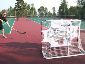 Joe Banfield shoots a road hockey ball into one of the nets on the tennis courts at the Royal Lake of the Woods Yacht Club. For the first time ever, the Yacht Club will be offering an adult ball hockey league on Sunday nights and youth league on Wednesday nights. 
GRACE PROTOPAPAS/KENORA DAILY MINER AND NEWS