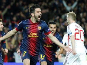Barcelona's David Villa celebrates after scoring a goal against AC Milan during Champions League play at Camp Nou stadium in Barcelona March 12, 2013. (REUTERS/Gustau Nacarino)