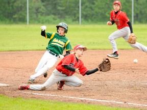 Ivan Danielewicz/special to Daily Herald-Tribune
Grande Prairie Reds third baseman Dawson Kokesch reaches out for the ball as Sherwood Park Gold’s Brandon Brusberger slides into the base behind him during their Baseball Alberta Competitive Division 1 game at Evergreen Park near Grande Prairie on July 6. Gold won 14-9.