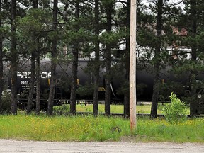The tanker car responsible for the evacuation of part of Gogama sat obscured by trees on Monday as it awaited specially trained CN technicians to assess the severity of the ammonia leak. Photo taken on Monday, July 8, 2013 in Gogama. KYLE GENNINGS/TIMMINS DAILY PRESS/QMI AGENCY