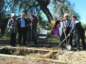 Family members and friends cover the body of Joseph Fitzgerald with soil during his funeral at the Prairie Creek Conservation Cemetery in Gainesville, Florida in February.