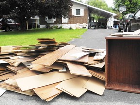 The pile of drenched flooring outside Alain Vachon’s Elgin Street home looks nearly identical to his trash pile in the fall of 2010, the last time basements in the area flooded.
Staff photo/CHERYL BRINK